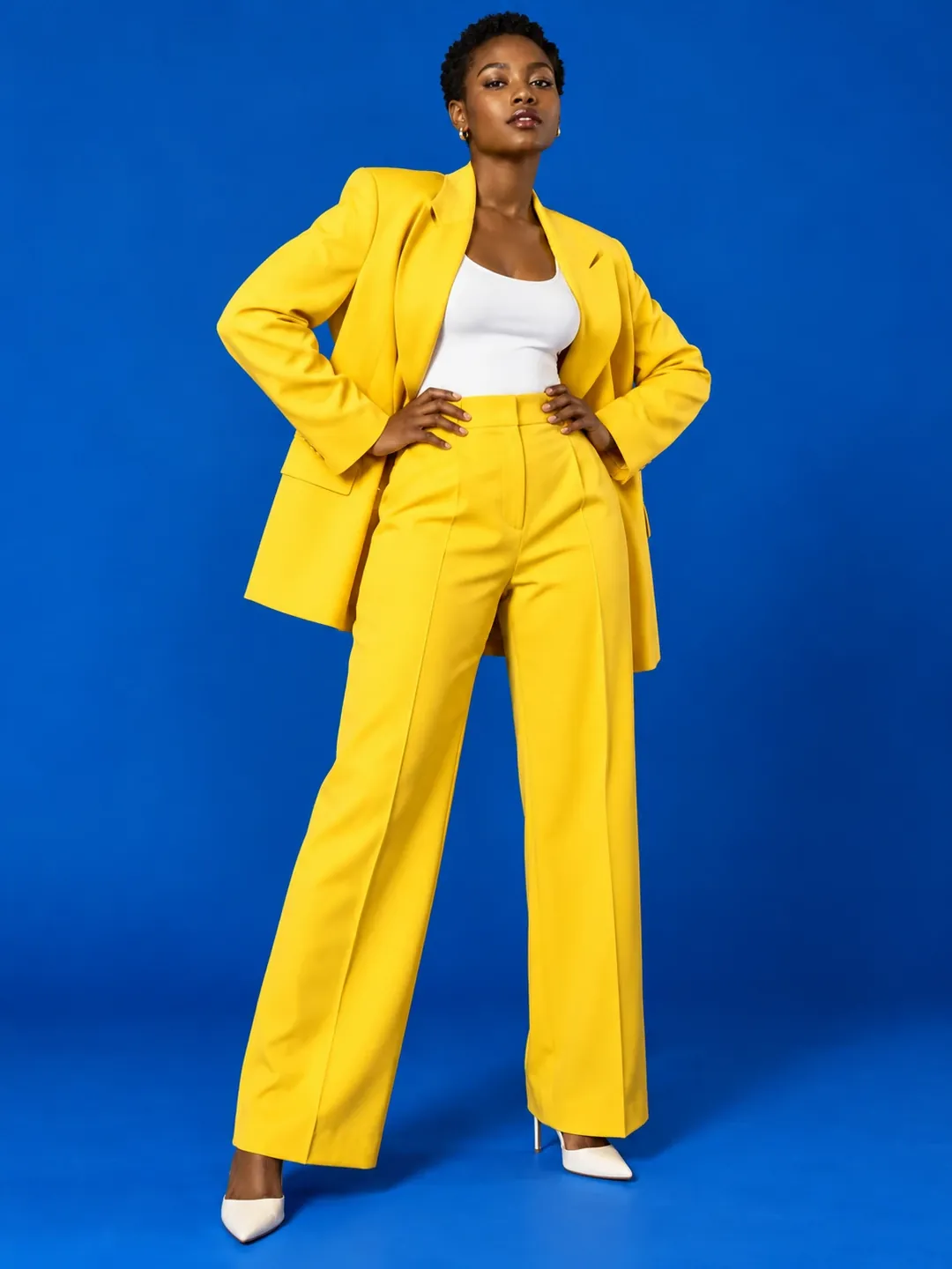 Yellow blazer on blue backdrop studio AI photoshoot